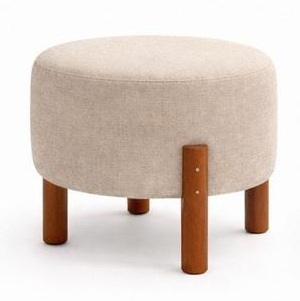 Puff redondo en tela crema beige con patas de madera vistas